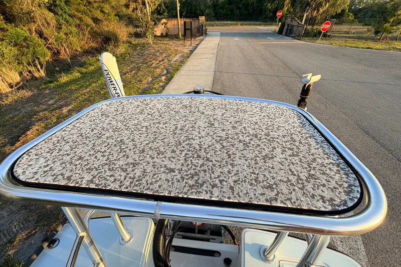 Slide: The Image of 2025 Chittum Skiffs Islamorada 21 boat with textured deck, parked near a road. - 77