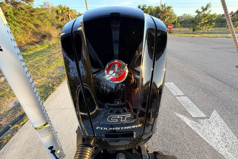 Slide: The Image of Close-up of a 2025 Chittum Skiffs Islamorada 21 outboard motor on a sunny day. - 78