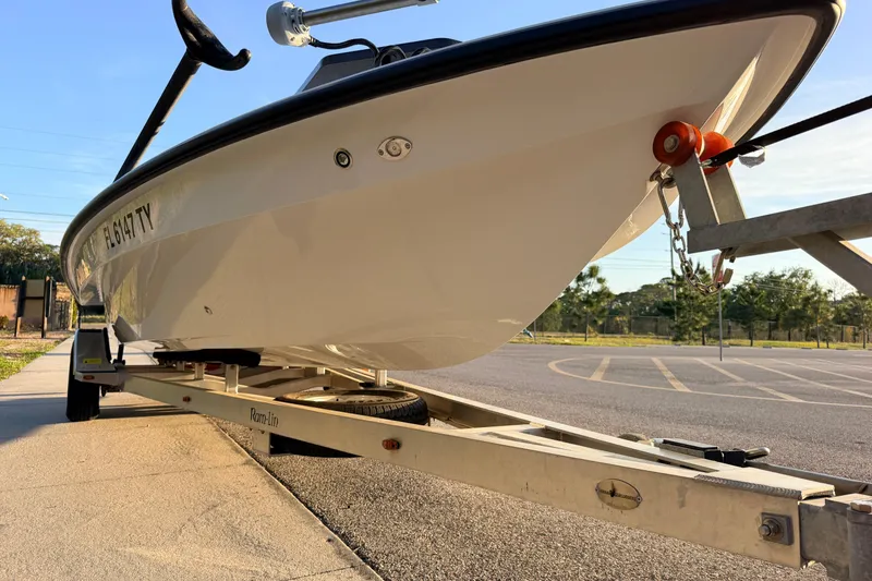 Slide: The Image of 2025 Chittum Skiffs Islamorada 21 boat on trailer in sunny parking lot. - 8