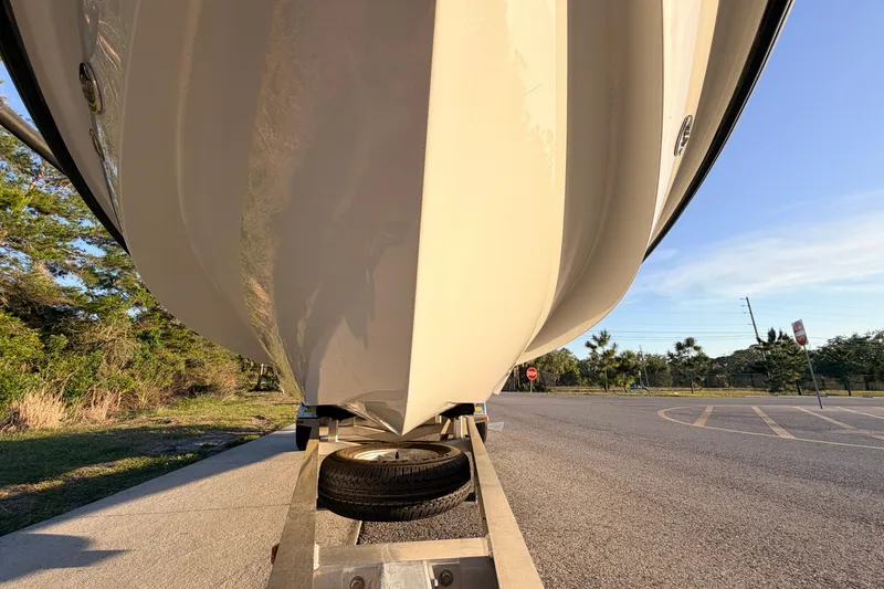 Slide: The Image of 2025 Chittum Skiffs Islamorada 21 boat on trailer, parked in sunny outdoor setting. - 9