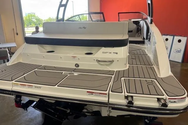 Slide: The Image of 2026 Sea Ray SPX 210 boat with spacious deck and modern design in showroom. - 3