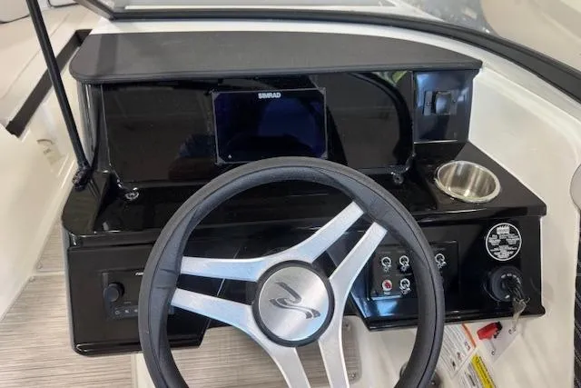 Slide: The Image of 2026 Sea Ray SPX 210 dashboard with steering wheel and control panel. - 5