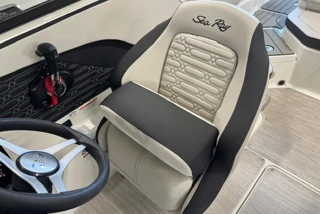 Slide: The Image of 2026 Sea Ray SPX 210 boat interior with luxury seating and steering wheel. - 9