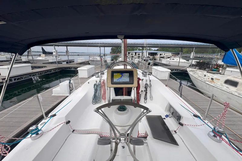 Slide: The Image of Cockpit view of a 2007 Hunter 27 sailboat docked at a marina. - 11