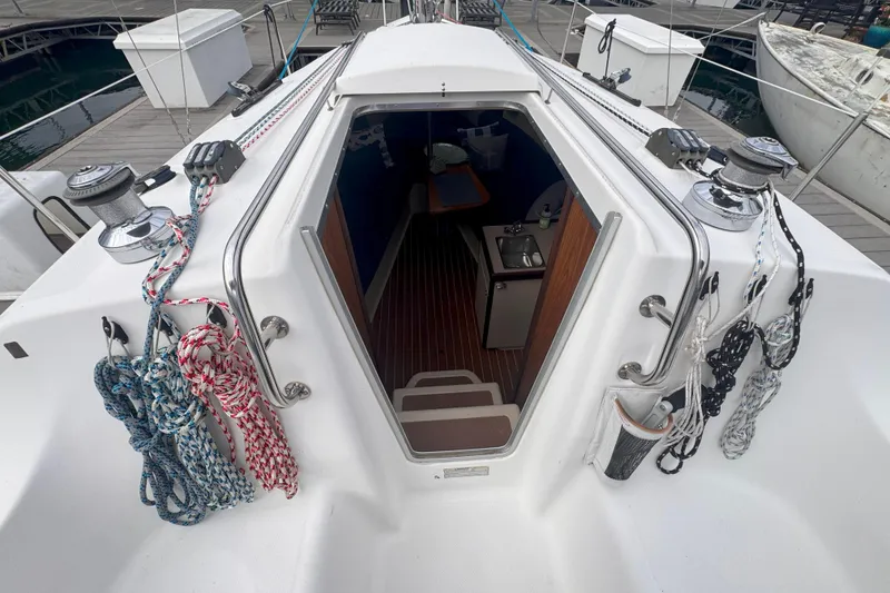 Slide: The Image of Cabin entrance of a 2007 Hunter 27 sailboat with ropes and winches visible. - 12