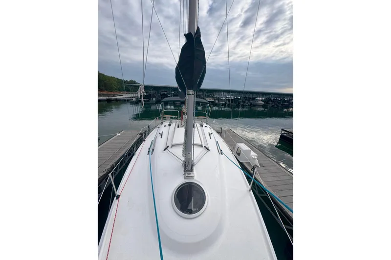 Slide: The Image of 2007 Hunter 27 sailboat docked at marina under cloudy sky. - 14