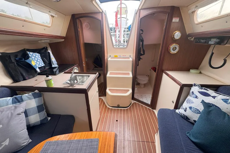 Slide: The Image of Interior of a 2007 Hunter 27 sailboat with cozy seating and compact kitchen. - 18
