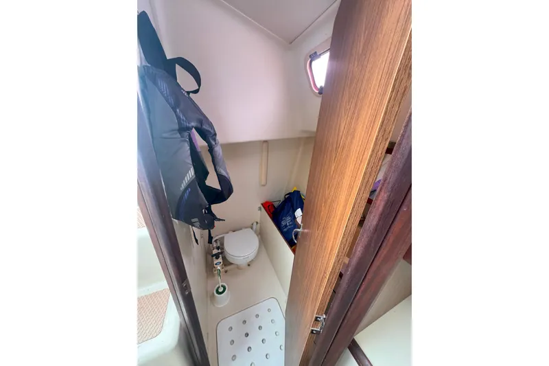 Slide: The Image of Interior of 2007 Hunter 27 sailboat bathroom with toilet and life jacket. - 19