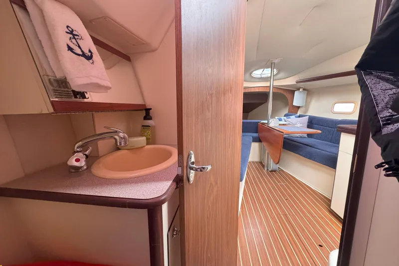Slide: The Image of Interior of a 2007 Hunter 27 sailboat featuring a compact bathroom and cozy seating area. - 20