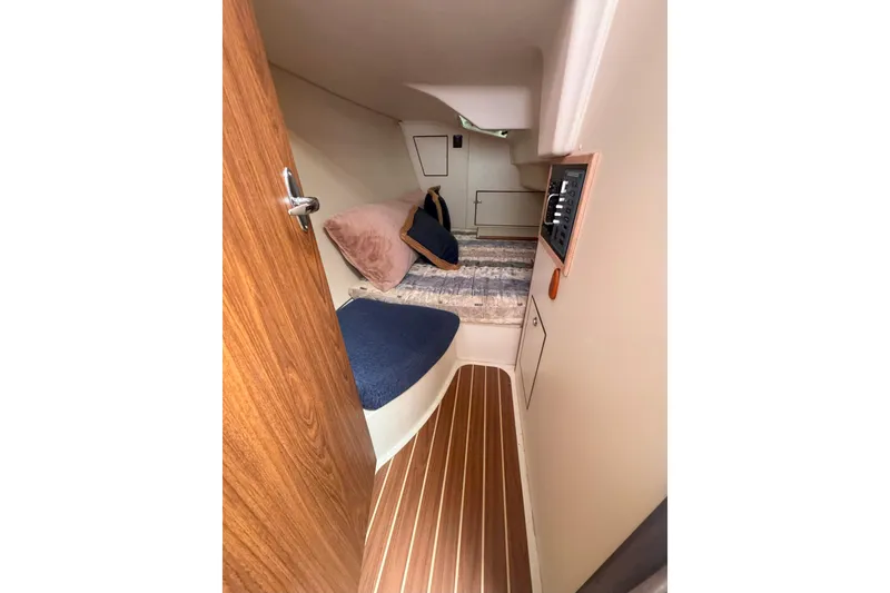 Slide: The Image of Cozy cabin interior of 2007 Hunter 27 sailboat with wood accents and bedding. - 21