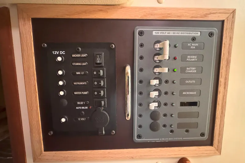 Slide: The Image of Electrical control panel on a 2007 Hunter 27 boat, featuring 12V DC and 120V AC systems. - 22