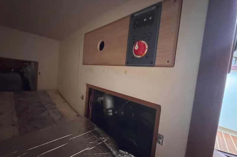 Slide: The Image of Interior view of a 2007 Hunter 27 sailboat showing control panel and storage compartment. - 23