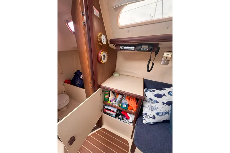 Slide: The Image of Interior of a 2007 Hunter 27 sailboat with storage, radio, and nautical decor. - 29
