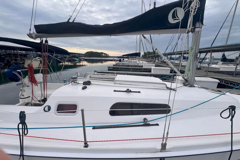Slide: The Image of 2007 Hunter 27 sailboat docked at marina under cloudy sky. - 5