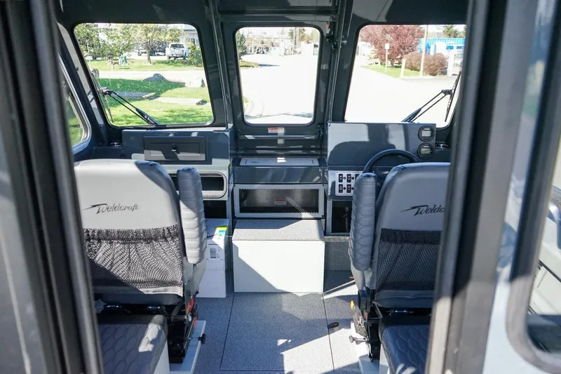 Slide: The Image of Interior of 2026 Weldcraft 210 Revolution boat with two seats and control panel. - 11