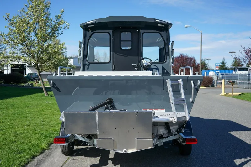 Slide: The Image of 2026 Weldcraft 210 Revolution boat, rear view, parked on a sunny day. - 4