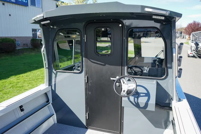 Slide: The Image of 2026 Weldcraft 210 Revolution boat cabin with steering wheel and windows. - 5