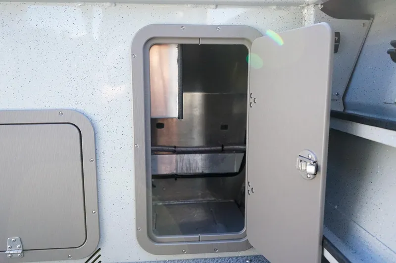 Slide: The Image of Open storage compartment on a 2026 Weldcraft 210 Revolution boat, showcasing interior space. - 9