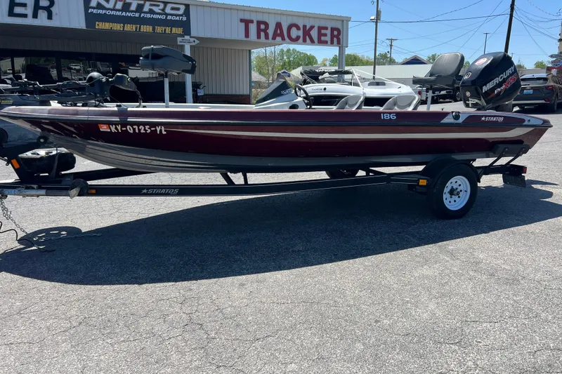 The Image of 2015 Stratos 186 VLO fishing boat on trailer, parked outside dealership. - 0