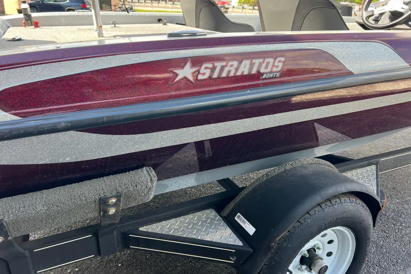 Slide: The Image of Stratos 186 VLO 2015 boat on trailer, featuring maroon and silver design. - 11