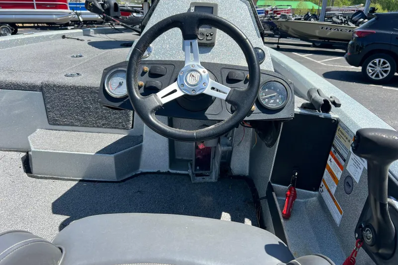 Slide: The Image of Steering console of a 2015 Stratos 186 VLO boat, featuring gauges and controls. - 4