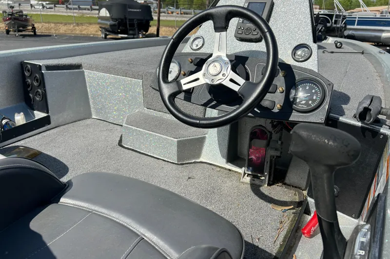 Slide: The Image of Interior of a 2015 Stratos 186 VLO boat with steering wheel and dashboard controls. - 9