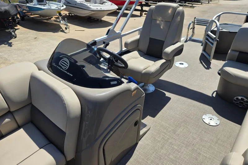 Slide: The Image of 2023 Sun Tracker SportFish 20 DLX pontoon boat interior with steering console and seating. - 11