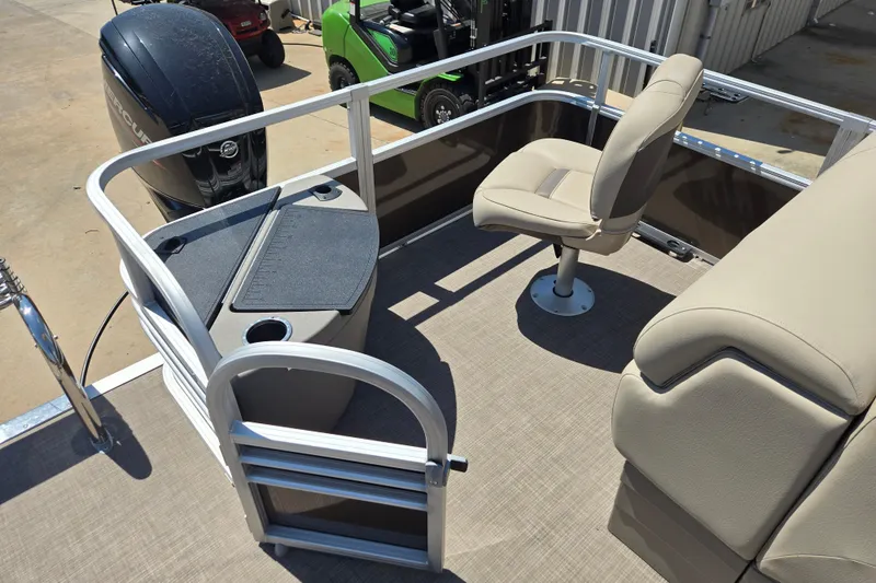 Slide: The Image of 2023 Sun Tracker SportFish 20 DLX pontoon boat interior with seating and motor. - 12