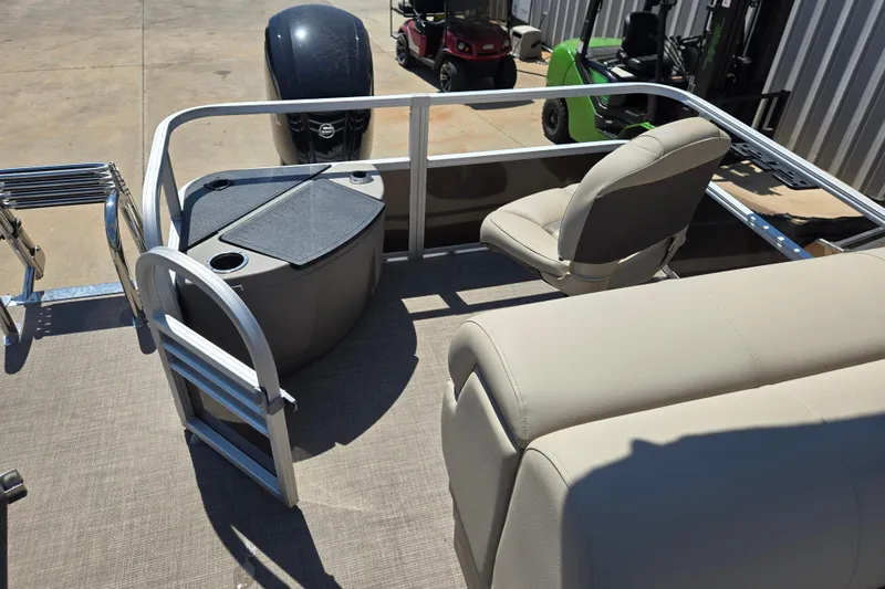 Slide: The Image of 2023 Sun Tracker SportFish 20 DLX pontoon boat interior with seating and motor view. - 13
