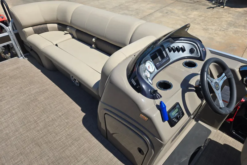 Slide: The Image of 2023 Sun Tracker SportFish 20 DLX boat interior with beige seating and modern dashboard. - 17