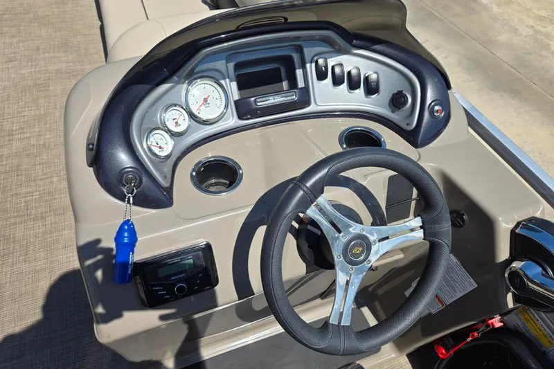 Slide: The Image of 2023 Sun Tracker SportFish 20 DLX dashboard with steering wheel and control panel. - 18