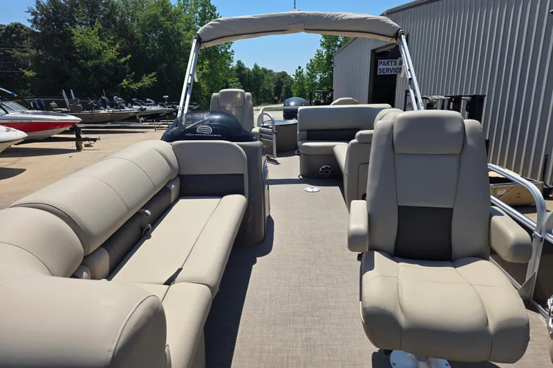 Slide: The Image of 2023 Sun Tracker SportFish 20 DLX pontoon boat with beige seating and canopy. - 9