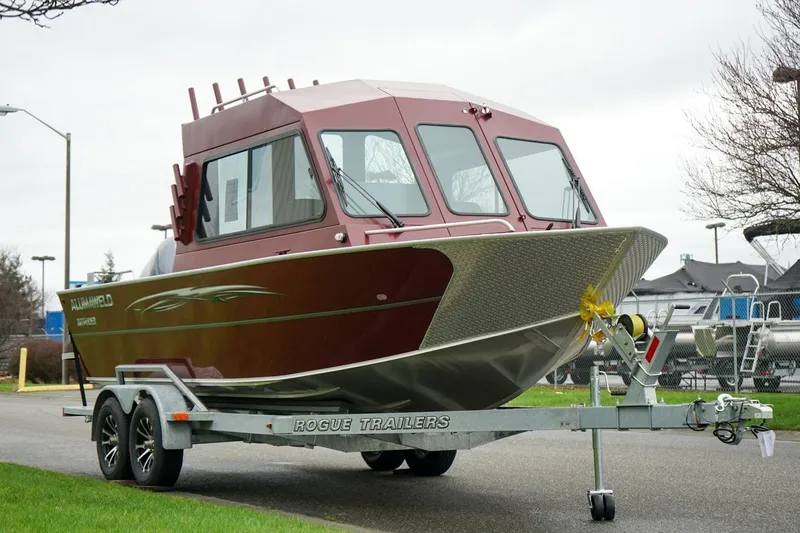The Image of 2026 Alumaweld Intruder Outboard 22 boat on trailer, parked outdoors. - 1
