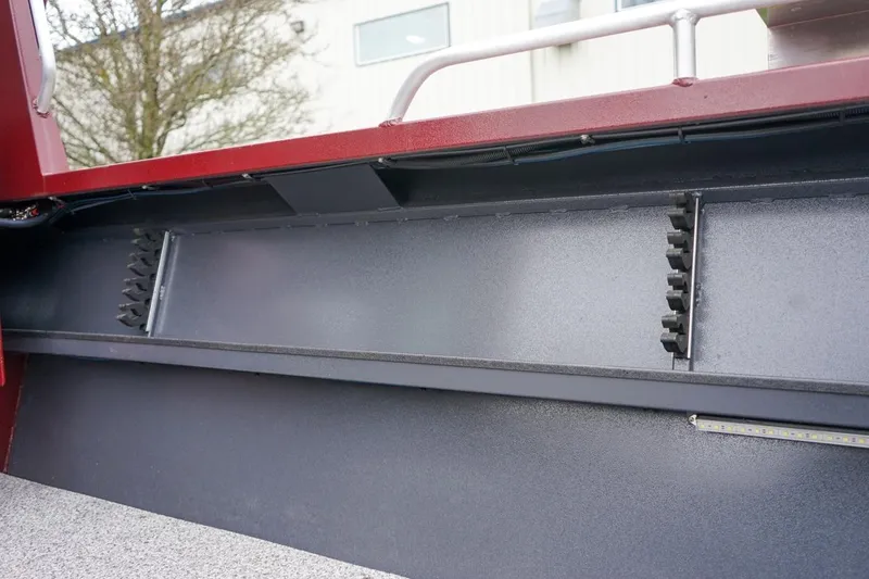 Slide: The Image of Interior view of 2026 Alumaweld Intruder Outboard 22 boat, showcasing storage compartments. - 10