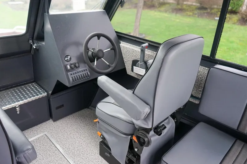 Slide: The Image of 2026 Alumaweld Intruder Outboard 22 boat interior with steering wheel and captain's chair. - 17