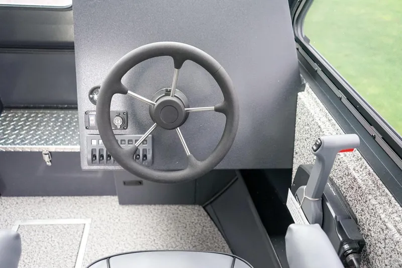 Slide: The Image of Steering console of 2026 Alumaweld Intruder Outboard 22 boat, featuring modern controls. - 18