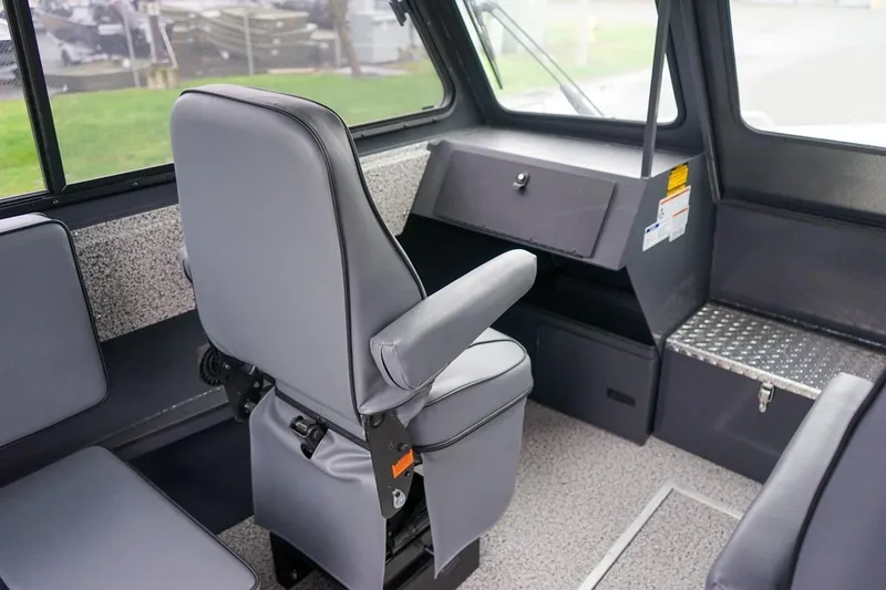 Slide: The Image of Interior of 2026 Alumaweld Intruder Outboard 22 boat with gray seating and dashboard. - 19