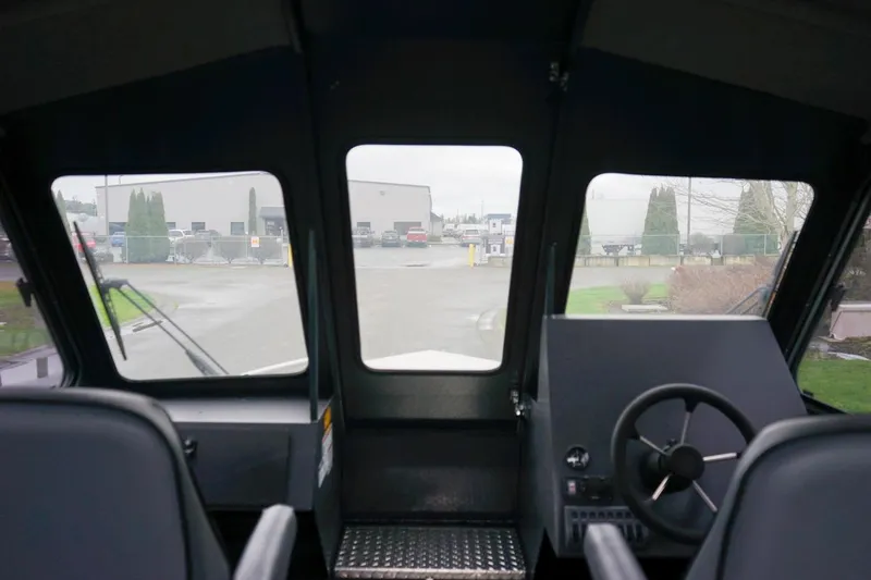 Slide: The Image of Interior view of 2026 Alumaweld Intruder Outboard 22 boat cockpit with steering wheel. - 20
