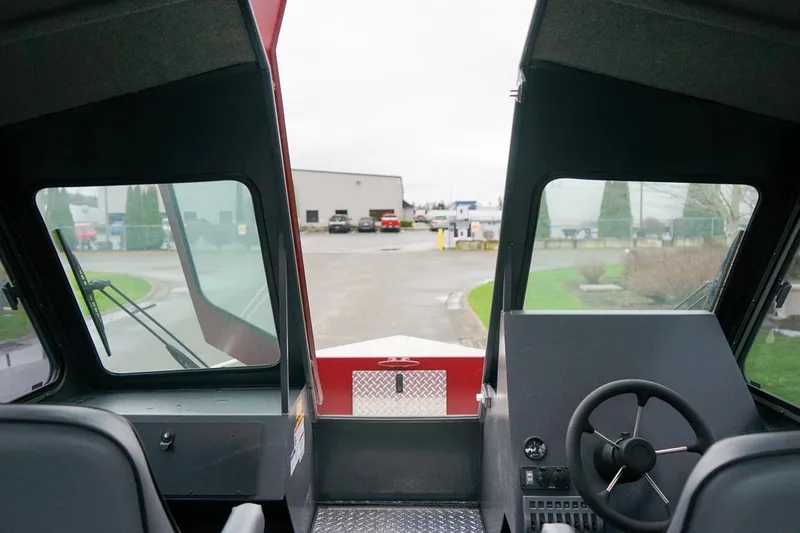 Slide: The Image of Interior view of 2026 Alumaweld Intruder Outboard 22 boat cockpit with steering wheel. - 21