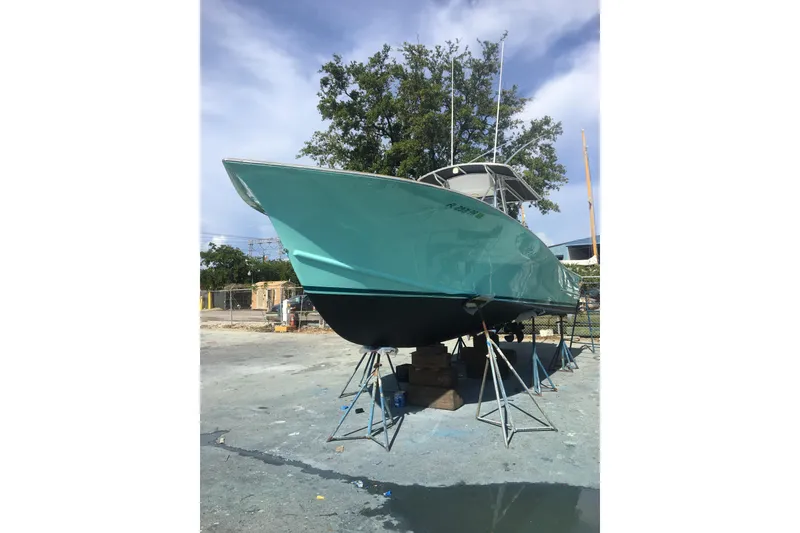 Slide: The Image of 1977 Scarborough 27 CC boat deck with sleek white finish and fishing rod holder. - 14