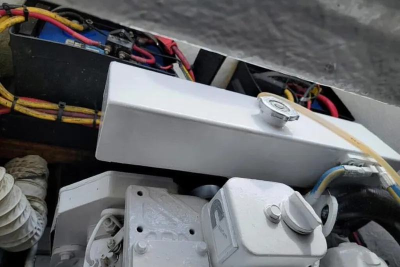 Slide: The Image of Engine compartment of a 1977 Scarborough 27 CC boat, showcasing detailed mechanical components. - 21