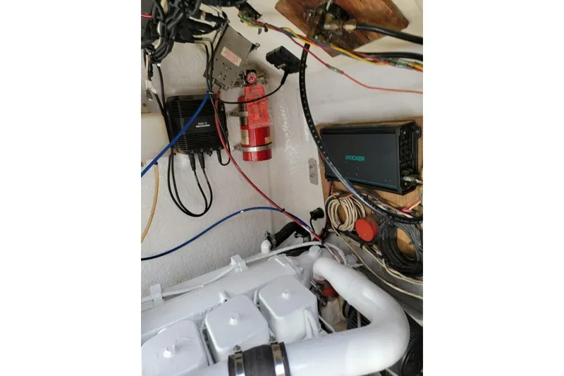 Slide: The Image of 1977 Scarborough 27 CC boat docked, surrounded by luxury yachts. - 22