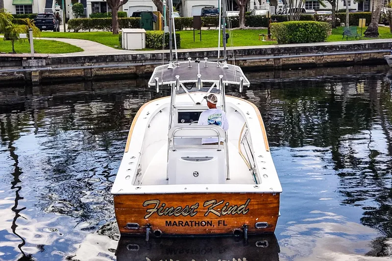 Slide: The Image of 1977 Scarborough 27 CC boat on water, labeled "Finest Kind," Marathon, FL. - 23