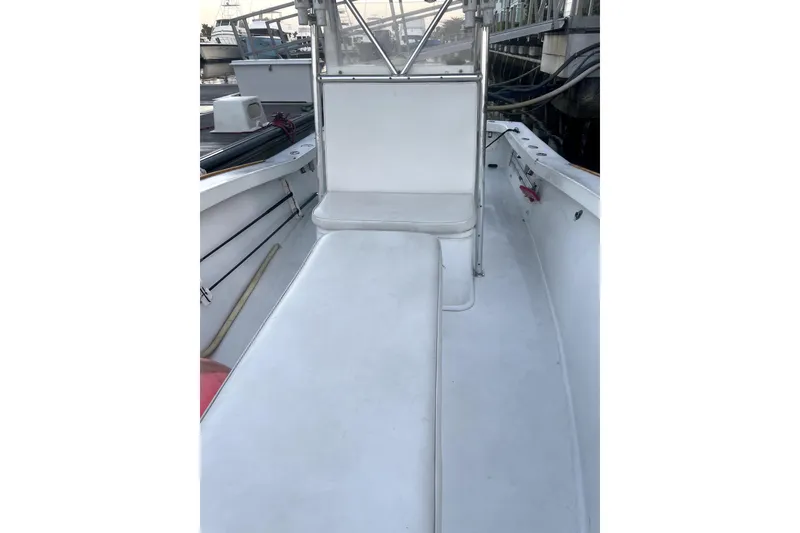 Slide: The Image of 1977 Scarborough 27 CC boat interior at dock, featuring clean white deck. - 3