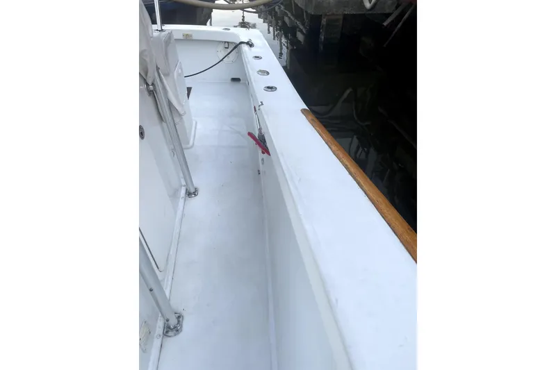 Slide: The Image of 1977 Scarborough 27 CC boat interior with docked yachts in background. - 4