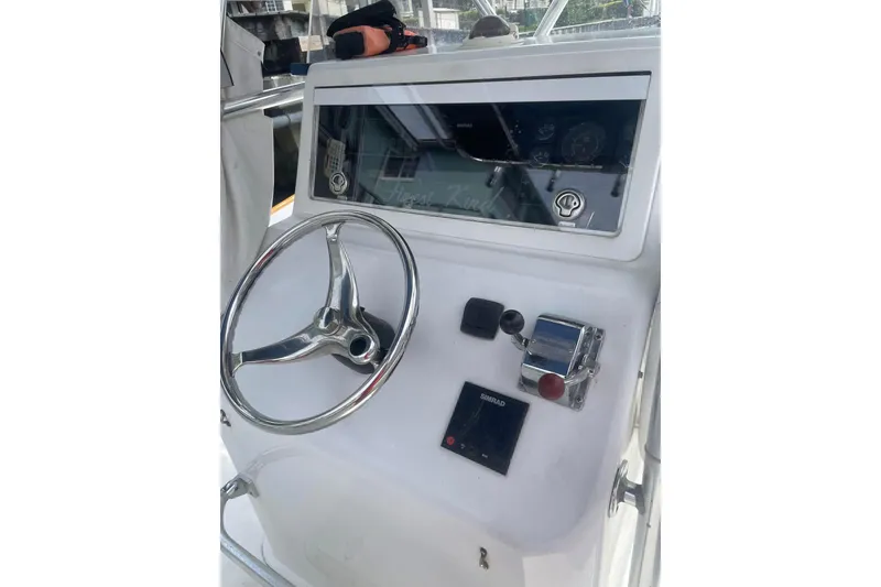 Slide: The Image of Storage compartment on a 1977 Scarborough 27 CC boat, containing organized tackle boxes. - 7