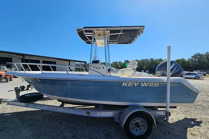 The Image of Key West 2020 Center Console boat on trailer, sunny day, outdoor storage area. - 1