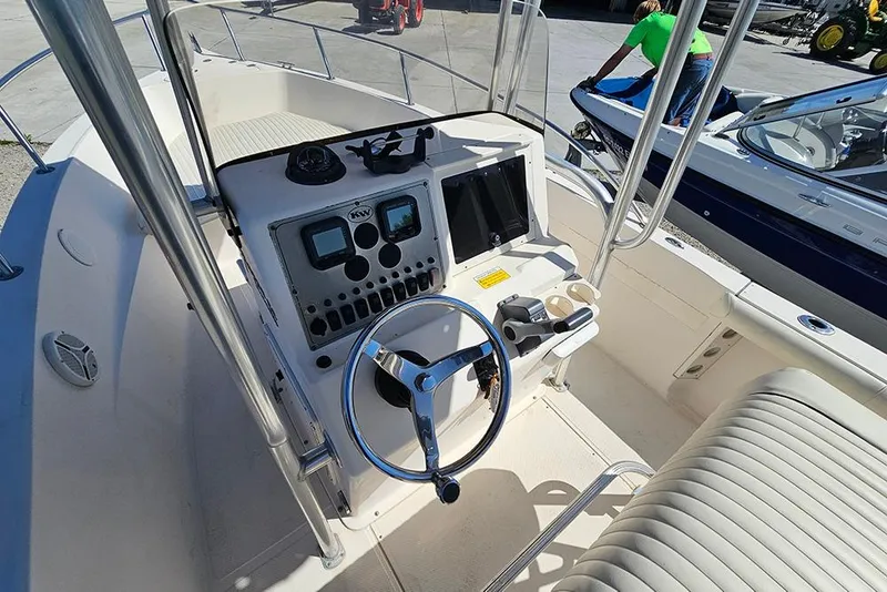 Slide: The Image of Center console of a 2008 Key West 2020 boat, featuring steering wheel and controls. - 11