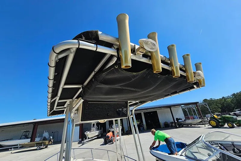 Slide: The Image of Key West 2020 Center Console boat with rod holders, docked outdoors under clear blue sky. - 12
