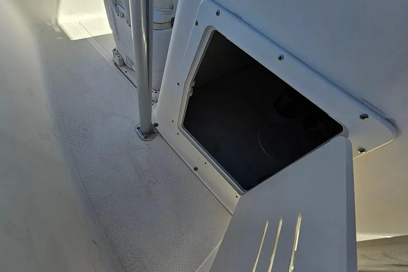 Slide: The Image of Open storage compartment on a 2008 Key West 2020 Center Console boat. - 13
